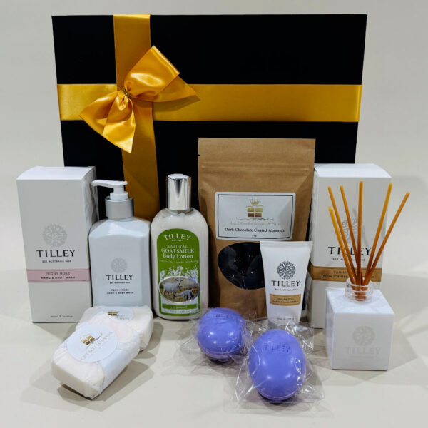 Harmony Hamper - indulgent treats, scented soaps and lotions, hand and body washes, lavender soap, hand and nail creams, reed diffusers, gourmet chocolates and nuts, gold-ribboned gift box.